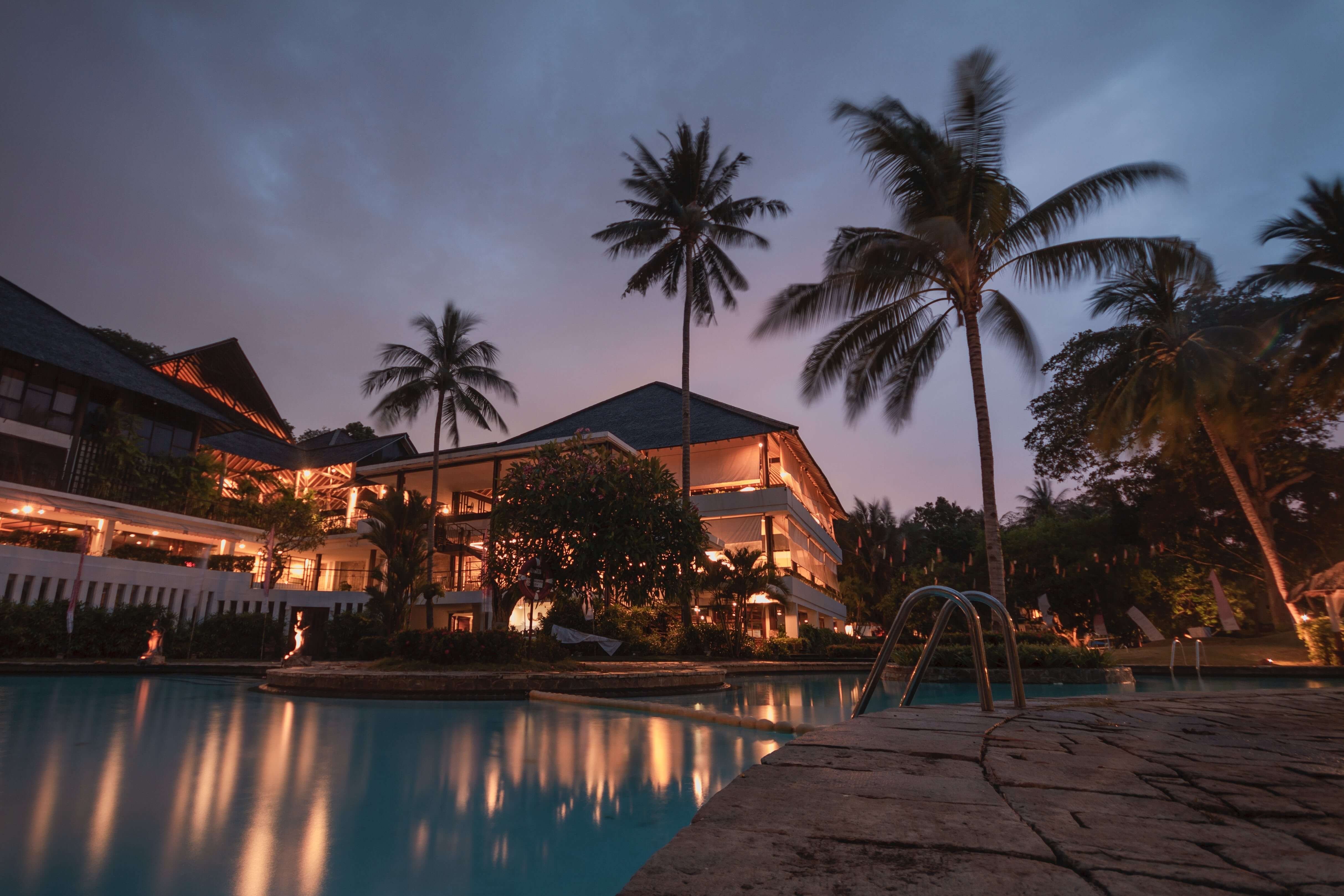 Image of a luxury hotel swimming pool at night